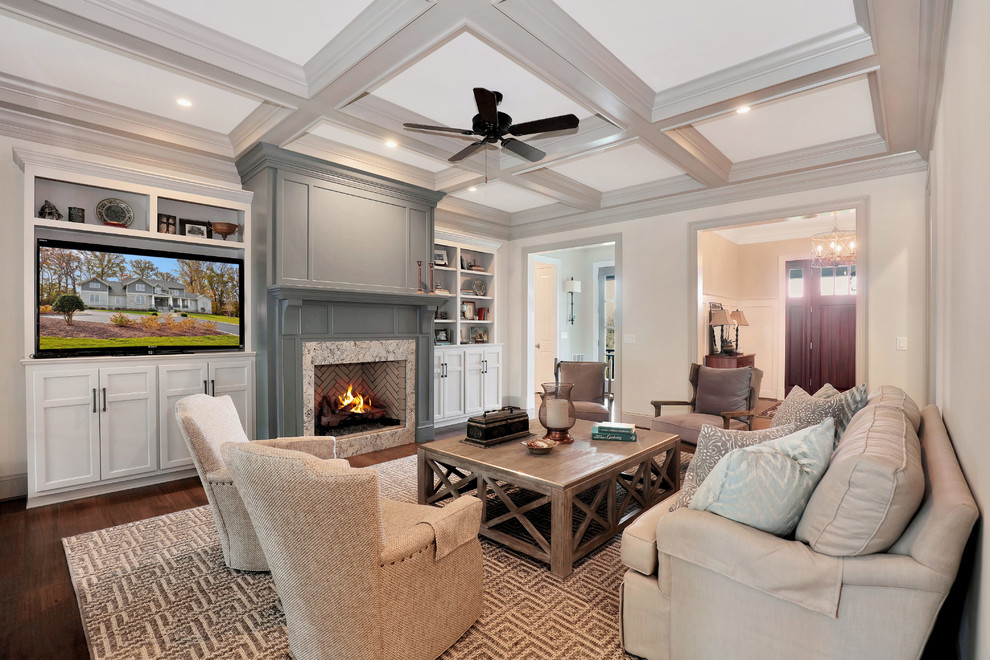 This is an example of a mid-sized arts and crafts enclosed family room in Richmond with white walls, medium hardwood floors, a standard fireplace, a tile fireplace surround and a built-in media wall.
