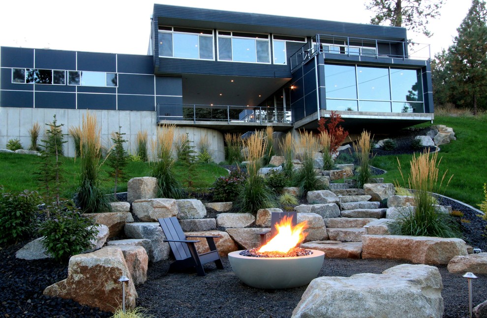 Inspiration for a backyard garden in Seattle with a fire feature and gravel.