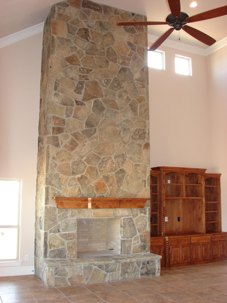 Photo of a country open concept family room in Dallas with a standard fireplace and a stone fireplace surround.