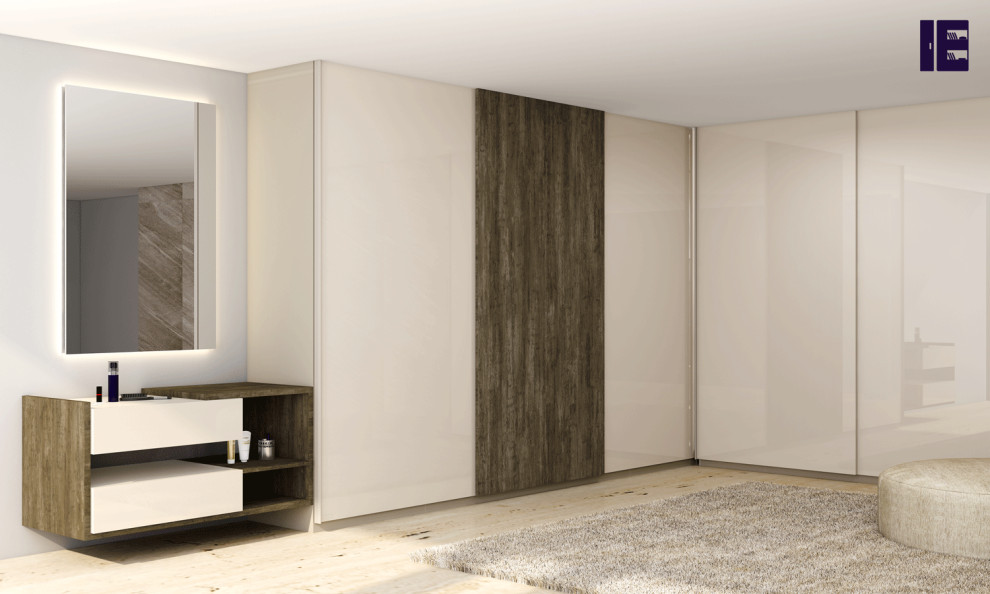This is an example of a large contemporary built-in wardrobe in London with flat-panel cabinets and dark wood cabinets.