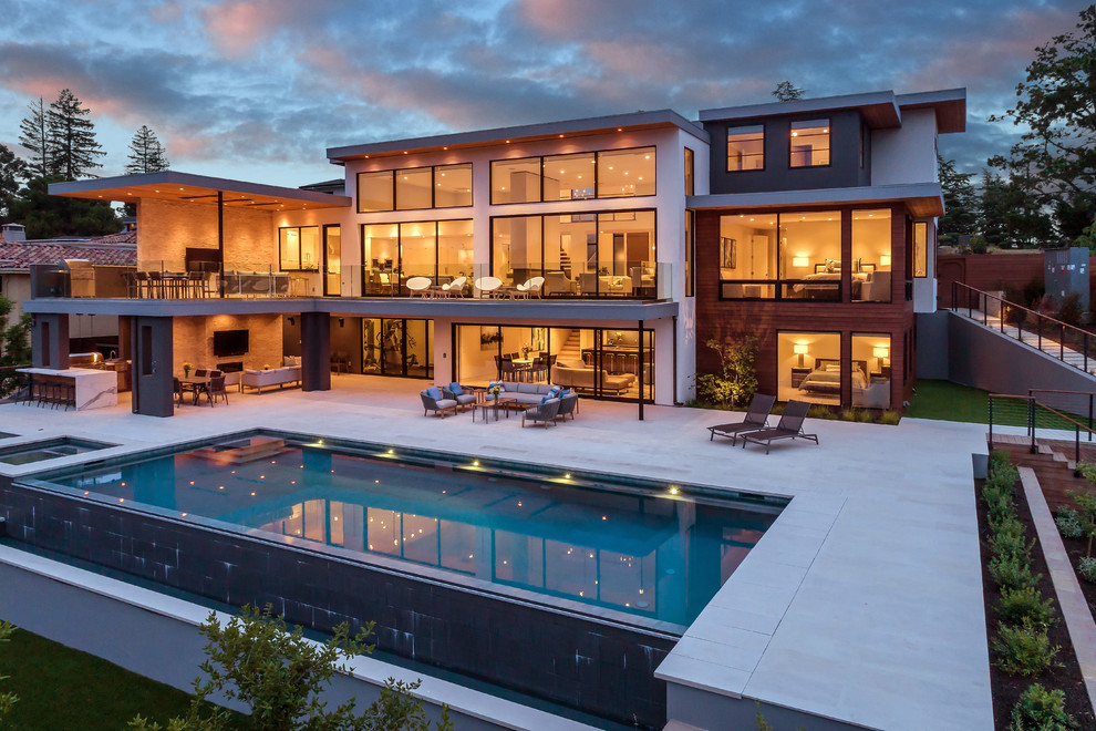 Expansive modern backyard rectangular lap pool in San Francisco with a hot tub.