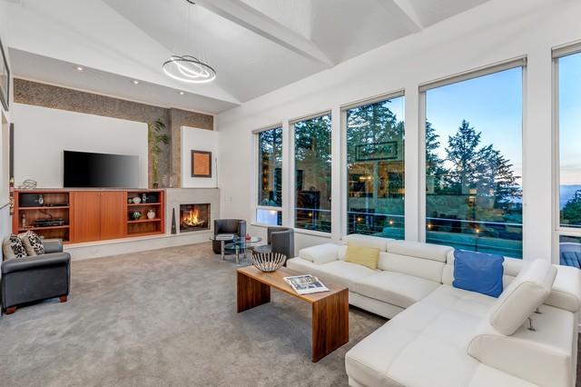 Living room - large modern open concept carpeted living room idea in Portland with white walls, a standard fireplace, a stone fireplace and a wall-mounted tv