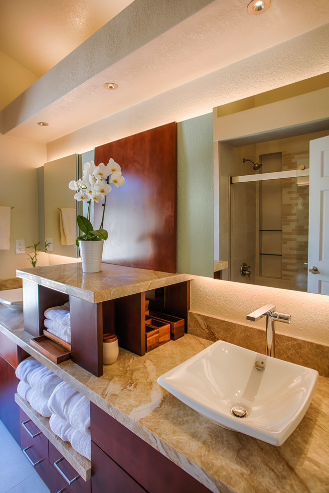 Small transitional beige tile and porcelain tile porcelain tile and beige floor alcove bathtub photo in Phoenix with flat-panel cabinets, medium tone wood cabinets, a one-piece toilet, beige walls, a vessel sink and granite countertops