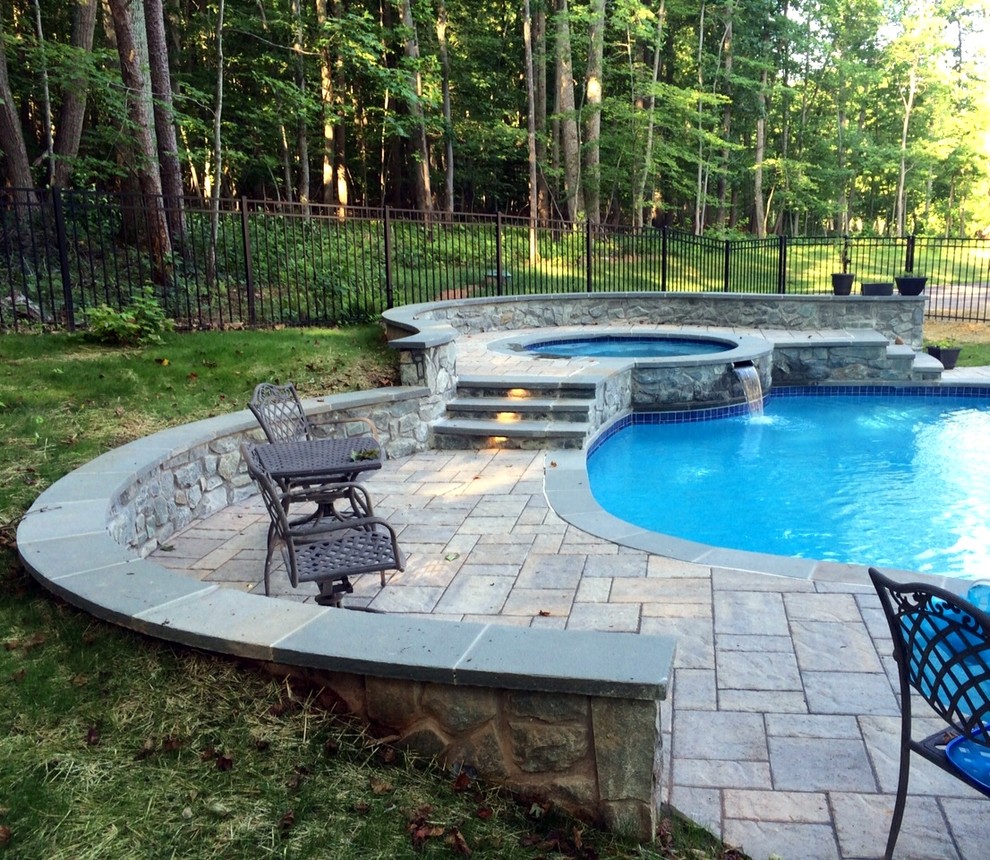 Example of a mid-sized transitional backyard concrete paver and custom-shaped natural hot tub design in DC Metro