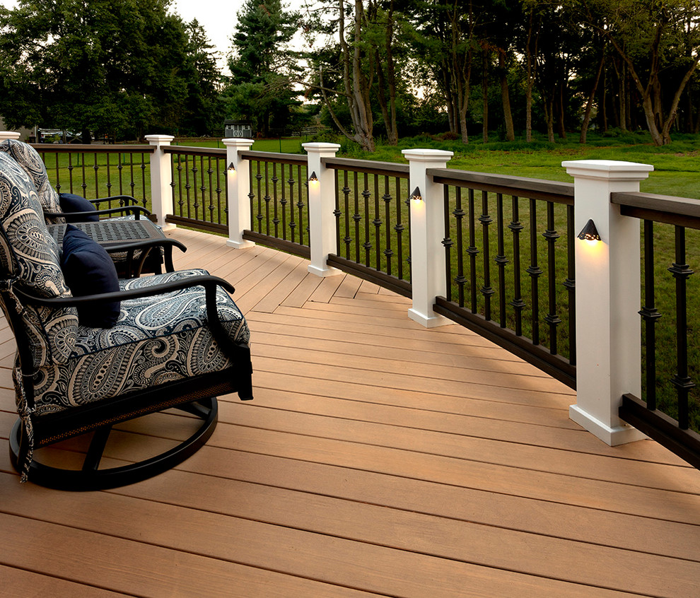 This is an example of a large arts and crafts backyard deck in Other with a roof extension.