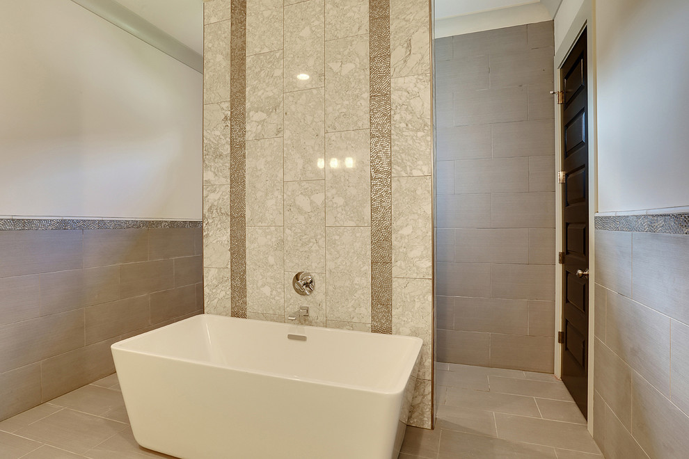 Inspiration for a large transitional master bathroom in New Orleans with raised-panel cabinets, white cabinets, a freestanding tub, an open shower, a one-piece toilet, gray tile, multi-coloured tile, white tile, ceramic tile, white walls, ceramic floors, a drop-in sink and granite benchtops.