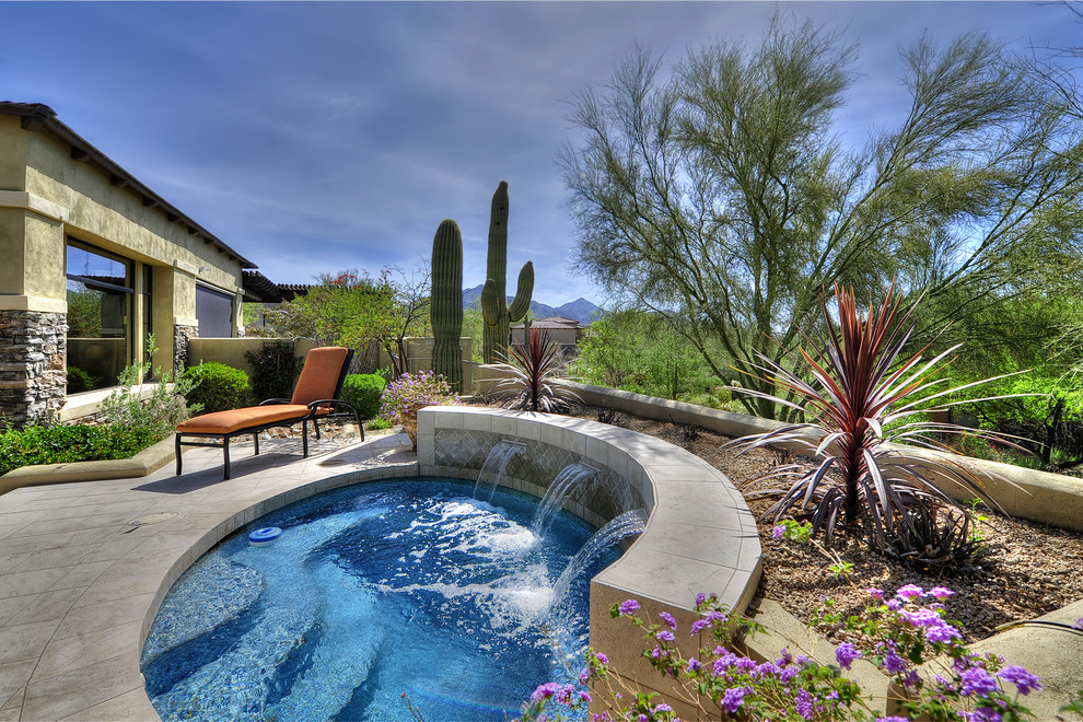 This is an example of a mediterranean pool in Phoenix with a water feature.