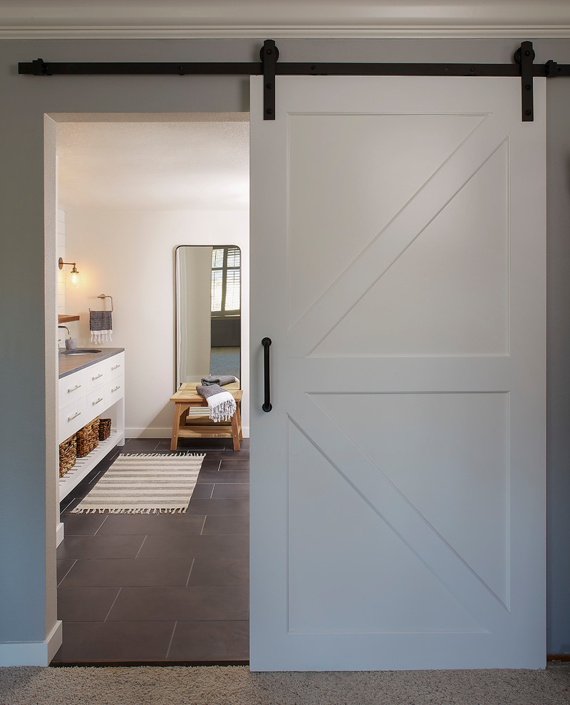 Inspiration for a mid-sized country master bathroom in San Francisco with a curbless shower, white tile, subway tile, white walls, porcelain floors, an undermount sink, black floor and an open shower.