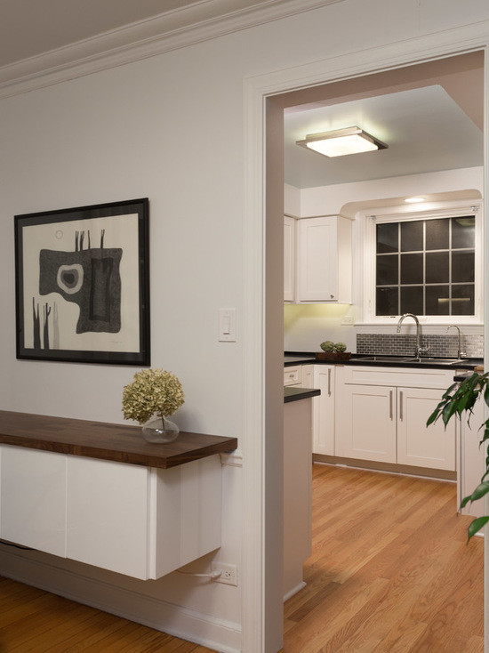 Enclosed kitchen - mid-sized transitional u-shaped medium tone wood floor enclosed kitchen idea in Chicago with a double-bowl sink, shaker cabinets, white cabinets, quartzite countertops, gray backsplash, subway tile backsplash, stainless steel appliances and no island