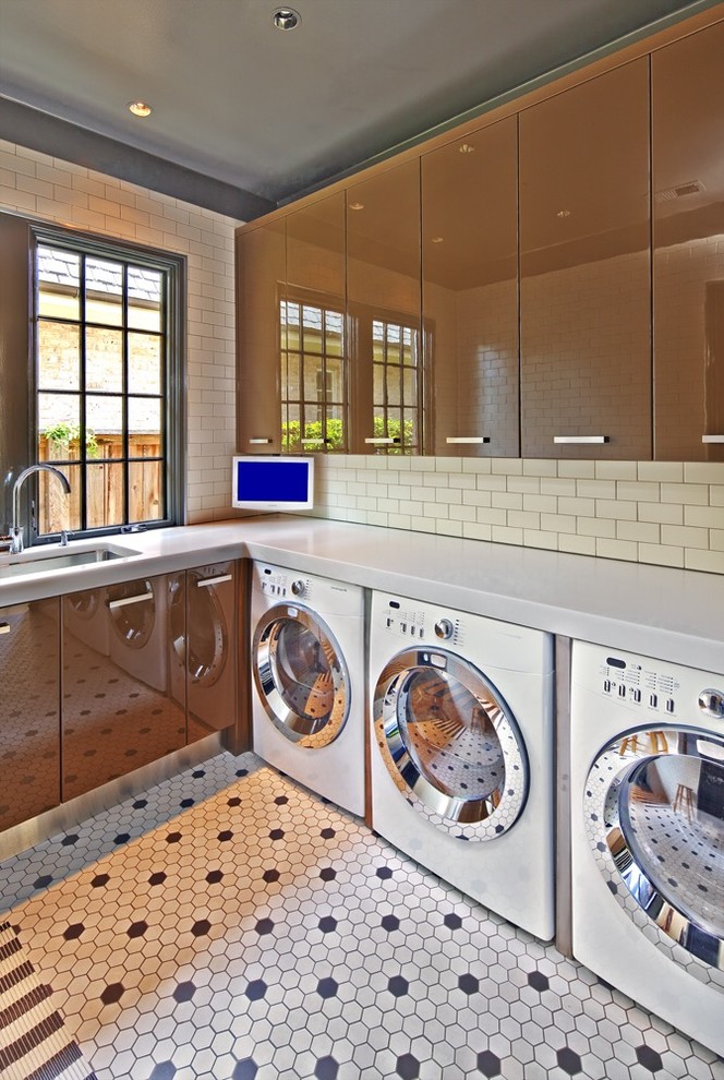 Inspiration for a mid-sized modern utility room in Houston with a single-bowl sink, flat-panel cabinets, quartzite benchtops, porcelain floors, a side-by-side washer and dryer, white walls and brown cabinets.