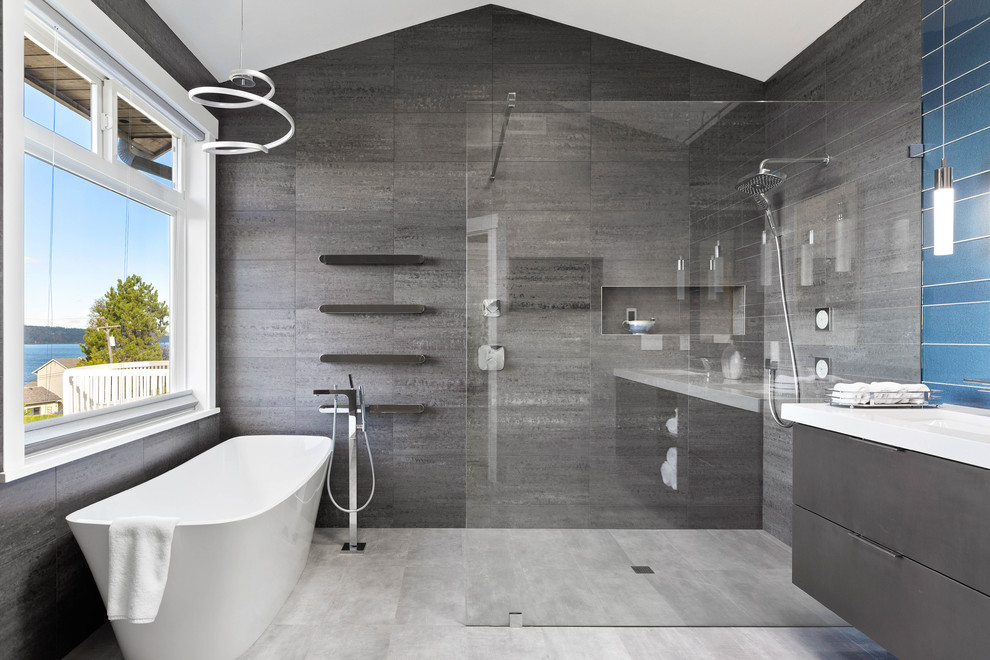 Design ideas for a large contemporary master wet room bathroom in Seattle with flat-panel cabinets, black cabinets, a freestanding tub, gray tile, blue tile, porcelain tile, grey walls, porcelain floors, an undermount sink, engineered quartz benchtops, grey floor, an open shower and white benchtops.