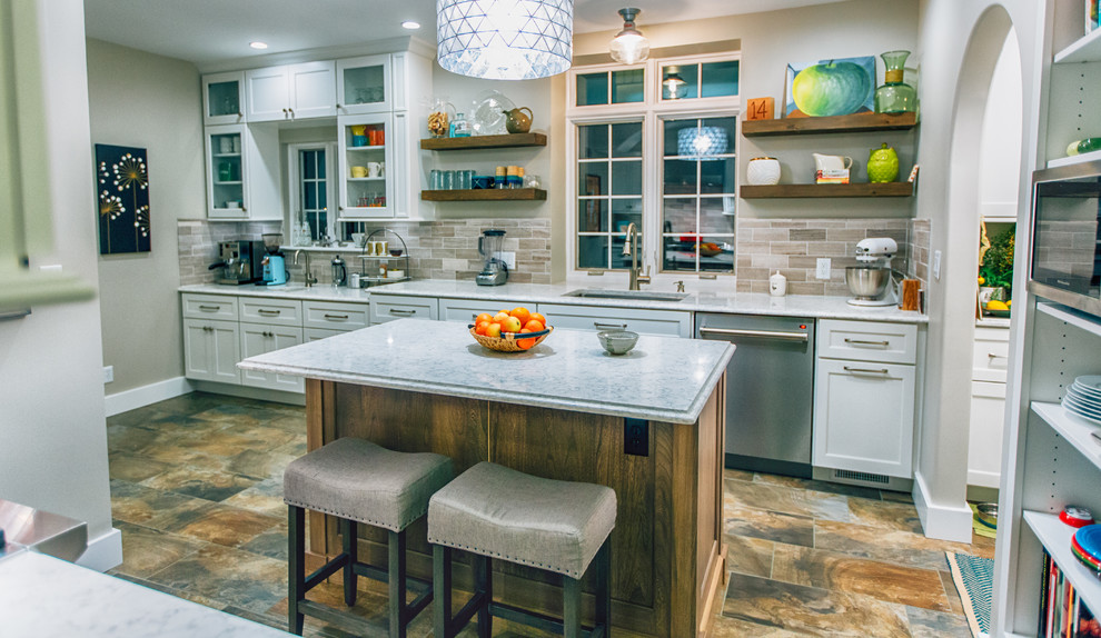 Inspiration for a small transitional kitchen remodel with an undermount sink, beige backsplash, ceramic backsplash, stainless steel appliances and an island