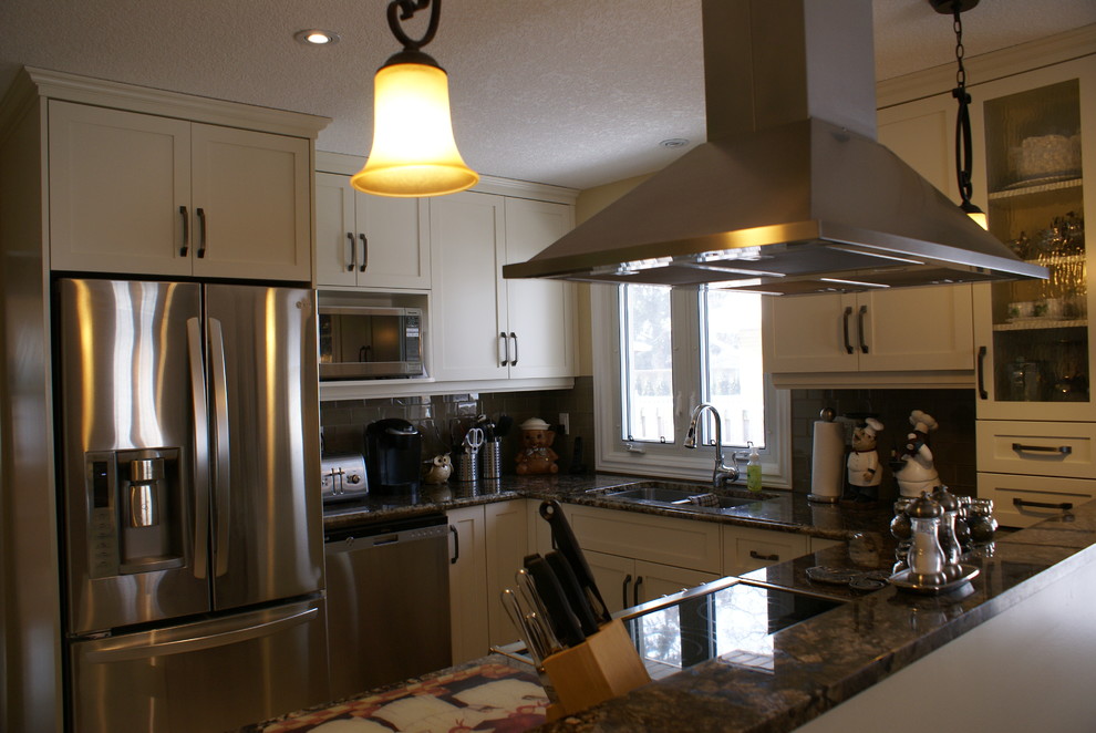Small transitional eat-in kitchen photo with recessed-panel cabinets, beige cabinets, granite countertops and stainless steel appliances