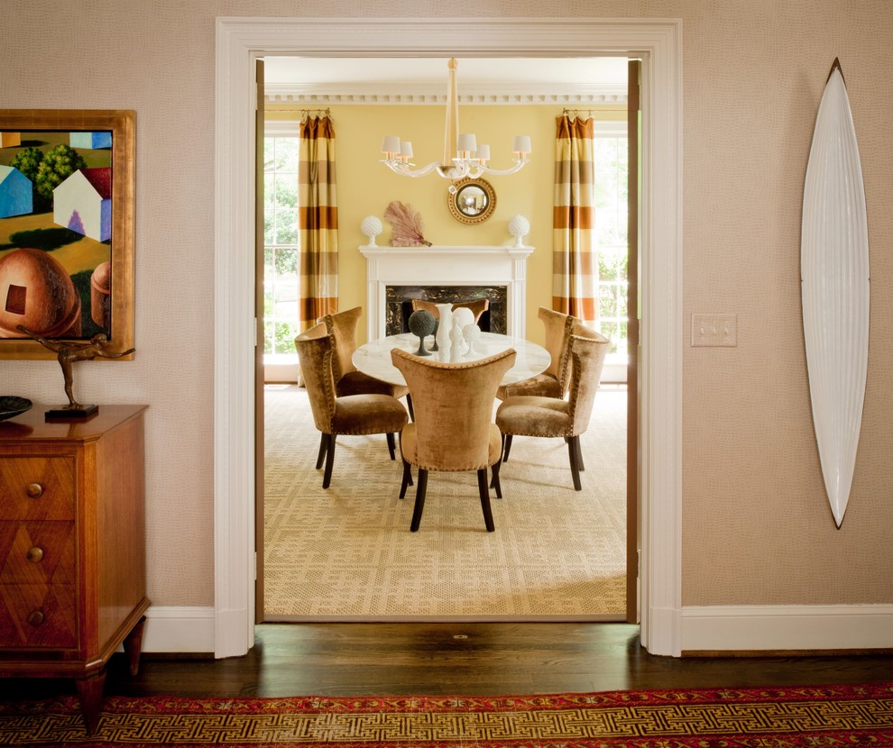 Photo of a transitional dining room in Charlotte with beige walls and dark hardwood floors.