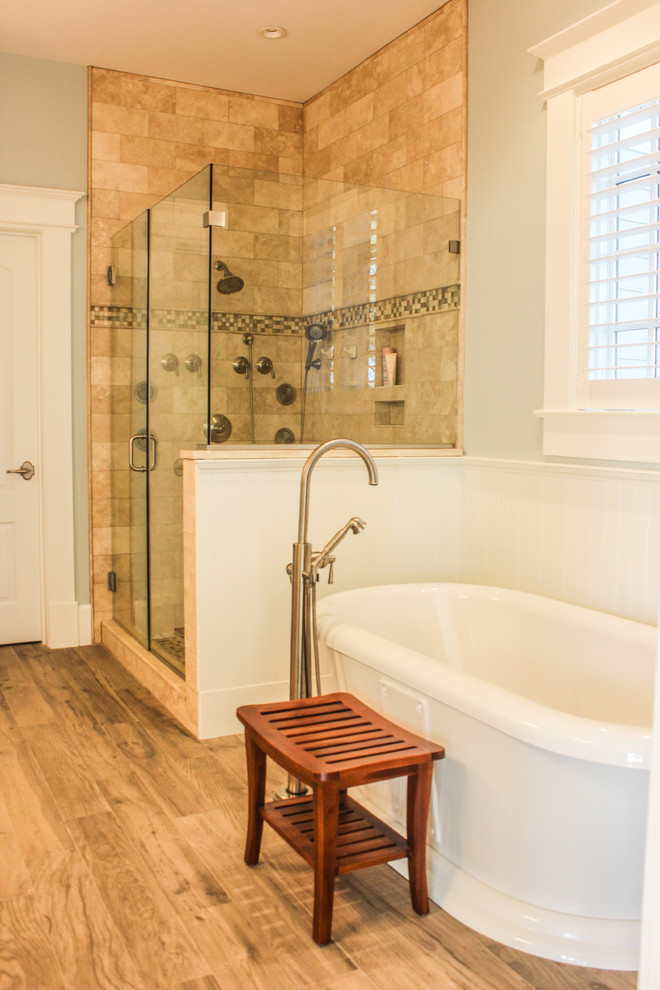 This is an example of a large traditional master bathroom in DC Metro with raised-panel cabinets, white cabinets, a claw-foot tub, an alcove shower, a one-piece toilet, multi-coloured tile, ceramic tile, blue walls, ceramic floors, an undermount sink and granite benchtops.