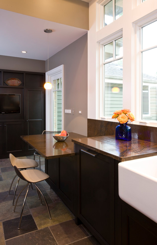 Transitional u-shaped open concept kitchen photo in Chicago with a farmhouse sink, recessed-panel cabinets, dark wood cabinets, granite countertops, brown backsplash, glass tile backsplash and paneled appliances