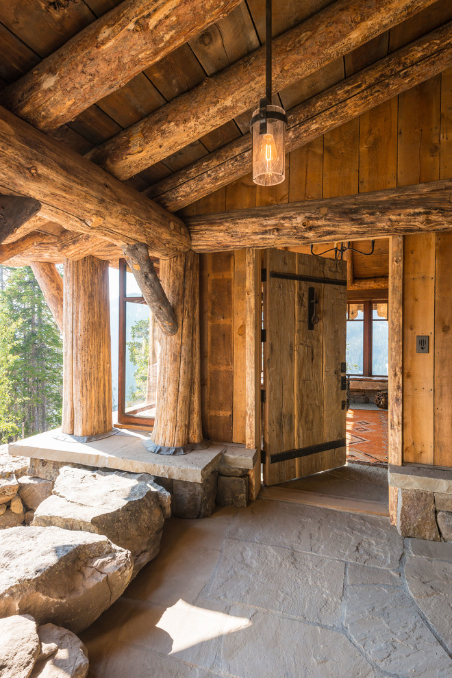 Example of a mountain style front door design with a medium wood front door