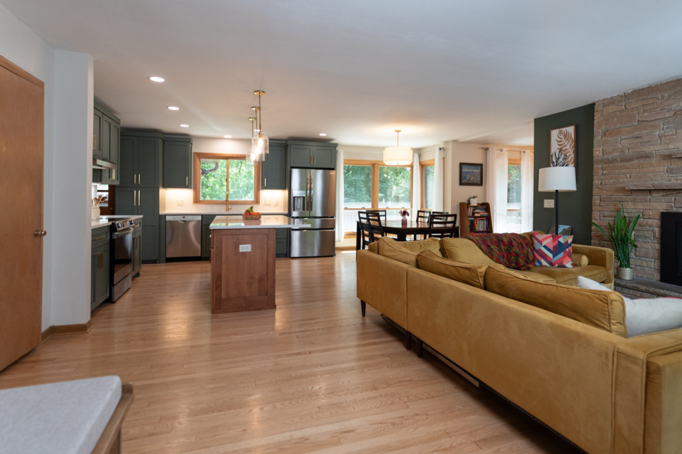 Kitchen - transitional light wood floor kitchen idea with shaker cabinets, green cabinets, quartz countertops, white backsplash, ceramic backsplash and an island