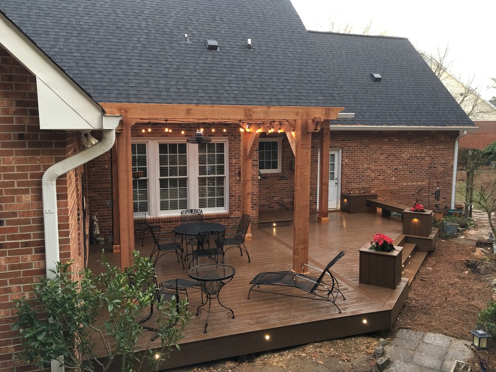 Inspiration for a large timeless backyard deck remodel with a pergola