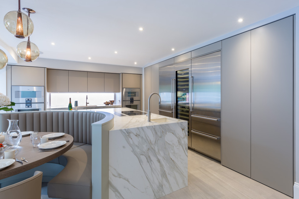 Inspiration for a large contemporary l-shaped open plan kitchen in Cheshire with flat-panel cabinets, grey cabinets, tile countertops, an island and white worktops.