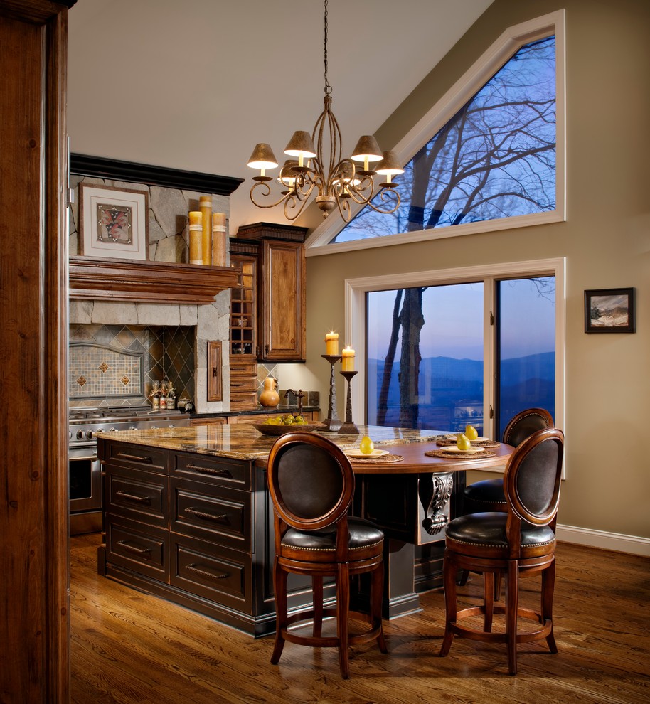 Example of a mid-sized mountain style l-shaped dark wood floor and brown floor enclosed kitchen design in Charlotte with raised-panel cabinets, dark wood cabinets, granite countertops, multicolored backsplash, stone tile backsplash, stainless steel appliances and an island