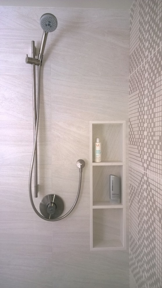 This is an example of a contemporary master bathroom in Burlington with a freestanding tub, an open shower and beige tile.