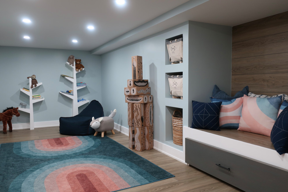 Design ideas for a mid-sized eclectic gender-neutral kids' playroom for kids 4-10 years old in Philadelphia with blue walls, light hardwood floors and brown floor.