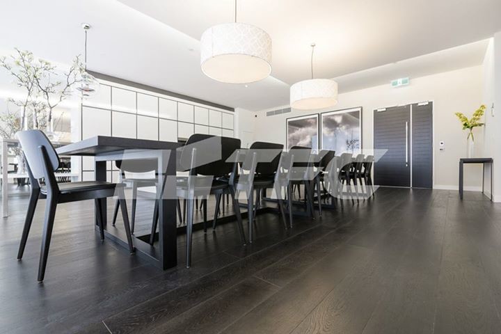 Photo of a large modern kitchen/dining combo in Melbourne with black walls.