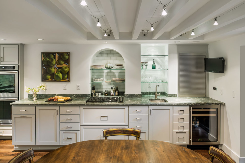 Inspiration for a large transitional l-shaped dark wood floor eat-in kitchen remodel in Boston with an undermount sink, shaker cabinets, white cabinets, onyx countertops, stone slab backsplash, stainless steel appliances and no island