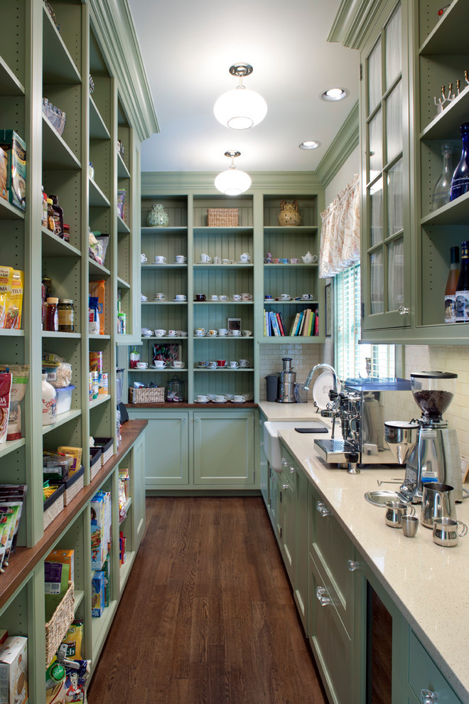 This is an example of a traditional kitchen pantry in Other with a farmhouse sink, recessed-panel cabinets, green cabinets, white splashback and dark hardwood floors.
