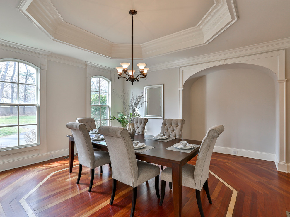 Photo of a mid-sized transitional separate dining room in New York with grey walls and medium hardwood floors.