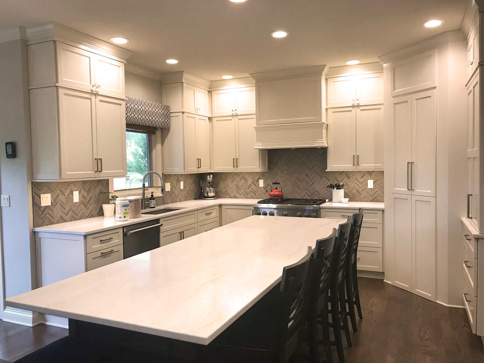 Transitional kitchen photo with flat-panel cabinets, white cabinets, quartz countertops, gray backsplash and white countertops