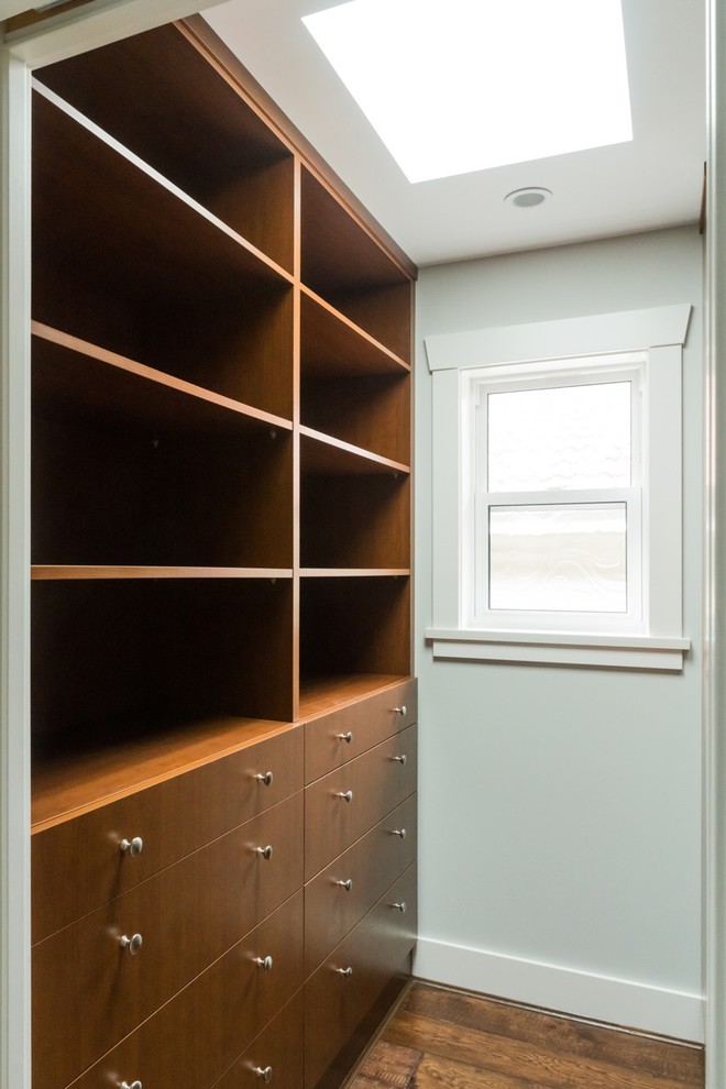 This is an example of a small arts and crafts walk-in wardrobe in Vancouver with flat-panel cabinets.