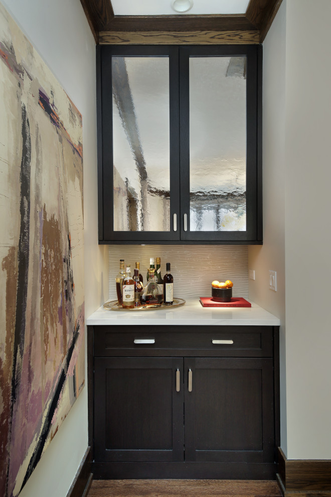 Design ideas for a large transitional home bar in Chicago with shaker cabinets and dark wood cabinets.