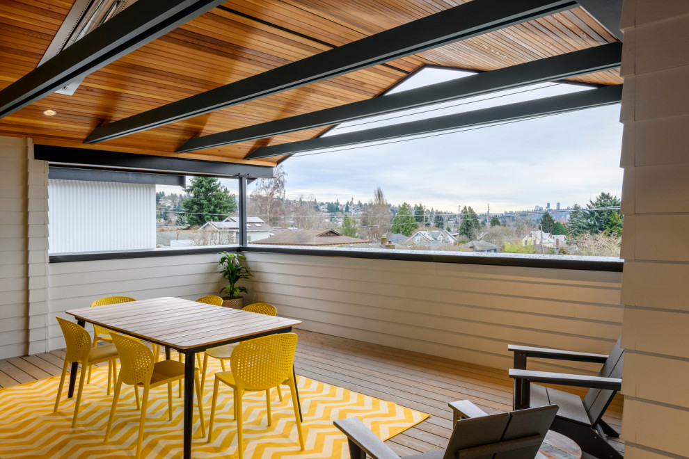 Mid-sized contemporary rooftop deck in Seattle with a roof extension.