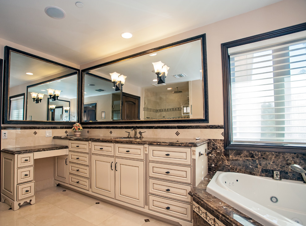 Design ideas for a large mediterranean master bathroom in Los Angeles with an undermount sink, shaker cabinets, beige cabinets, marble benchtops, a corner tub, an open shower, beige tile, stone tile, beige walls and marble floors.
