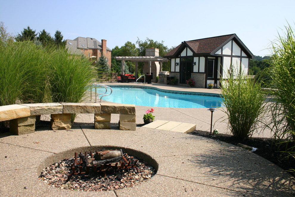 This is an example of a large arts and crafts backyard full sun garden in Other with a fire feature.