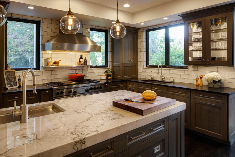 Inspiration for a large transitional l-shaped eat-in kitchen in Chicago with an undermount sink, flat-panel cabinets, medium wood cabinets, quartzite benchtops, white splashback, ceramic splashback, panelled appliances, dark hardwood floors, with island, brown floor and white benchtop.