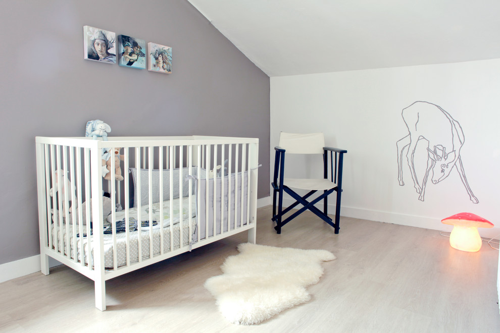 This is an example of a large contemporary gender-neutral nursery in Grenoble with grey walls, light hardwood floors and beige floor.