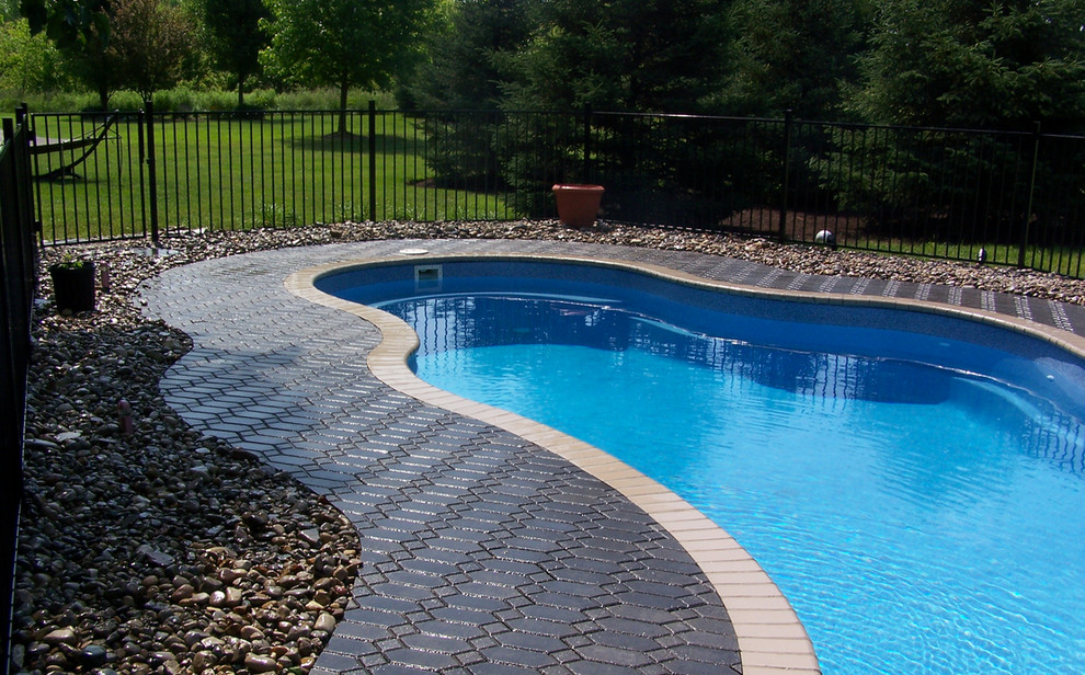Inspiration for a mid-sized backyard brick and custom-shaped natural pool remodel in Cincinnati