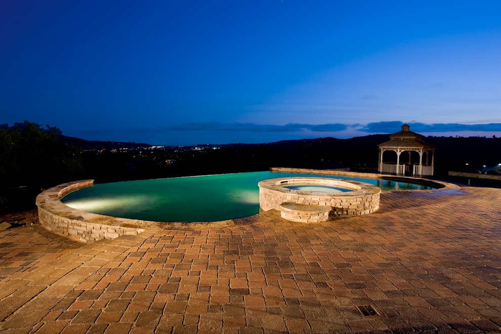 Pool - backyard concrete paver pool idea in Orange County