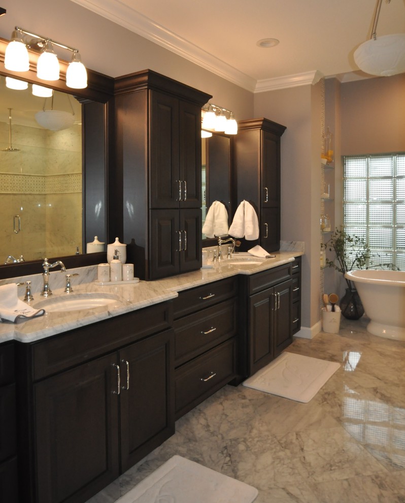 Freestanding bathtub - mid-sized transitional master marble floor freestanding bathtub idea in Miami with raised-panel cabinets, dark wood cabinets, marble countertops, an undermount sink and gray walls