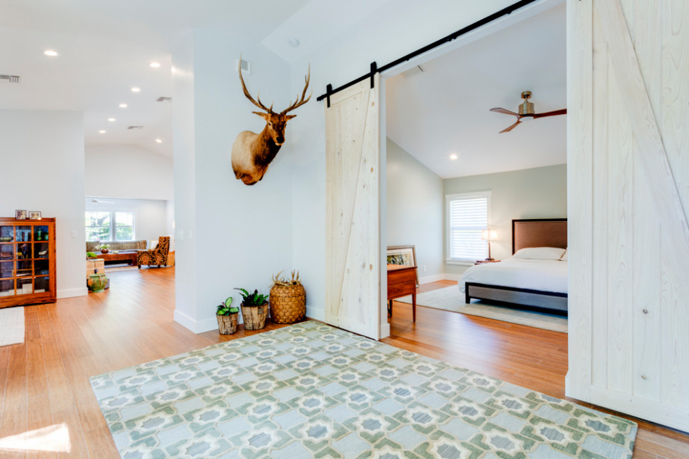 Inspiration for a large traditional master bedroom in Tampa with green walls, bamboo floors and vaulted.