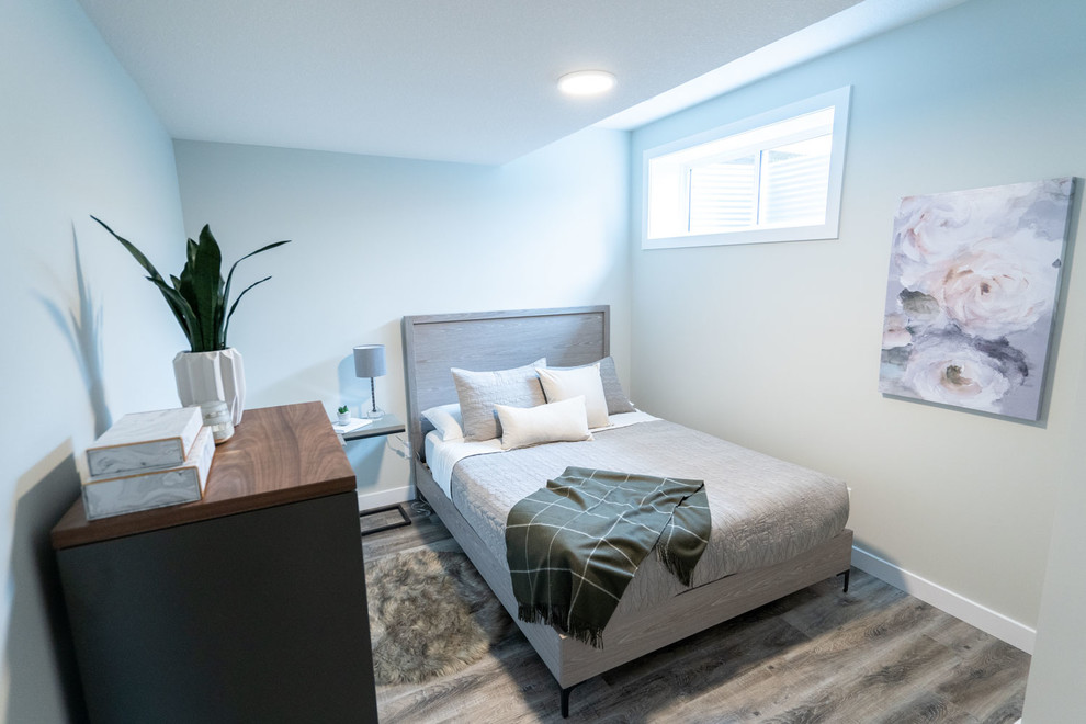 Basement - large transitional look-out laminate floor and beige floor basement idea in Edmonton with gray walls and no fireplace