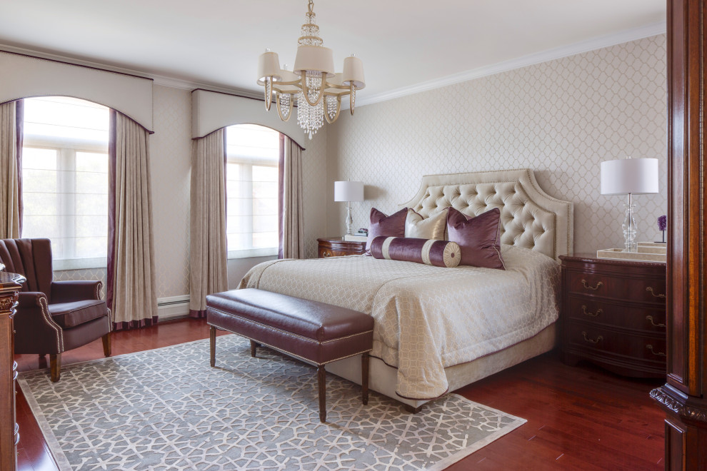 Inspiration for a traditional bedroom in New York with beige walls, dark hardwood floors, brown floor and wallpaper.