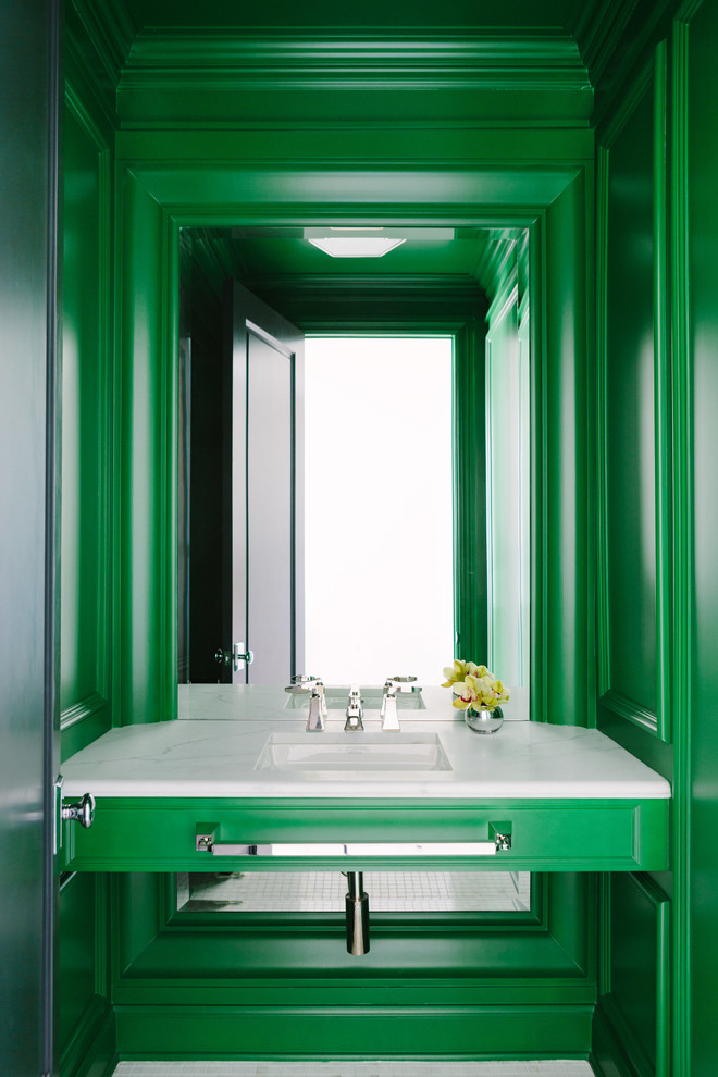 Mid-sized transitional white floor powder room photo in Chicago with green cabinets, green walls, an undermount sink, marble countertops and white countertops