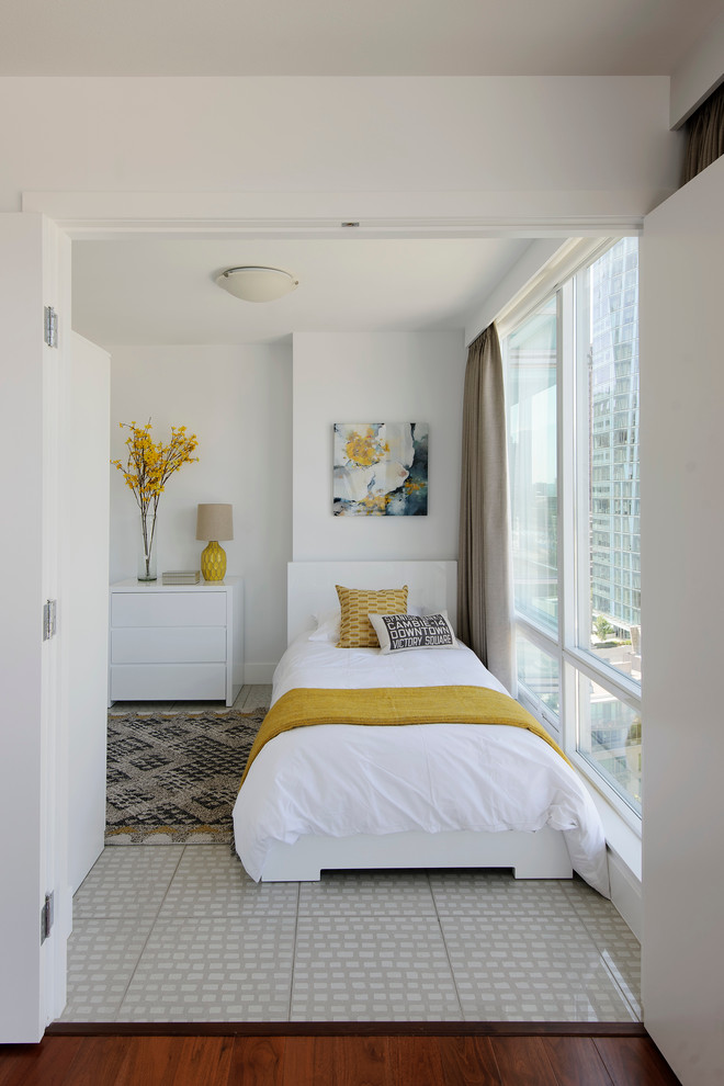 Design ideas for a small contemporary guest bedroom in Vancouver with white walls and porcelain floors.