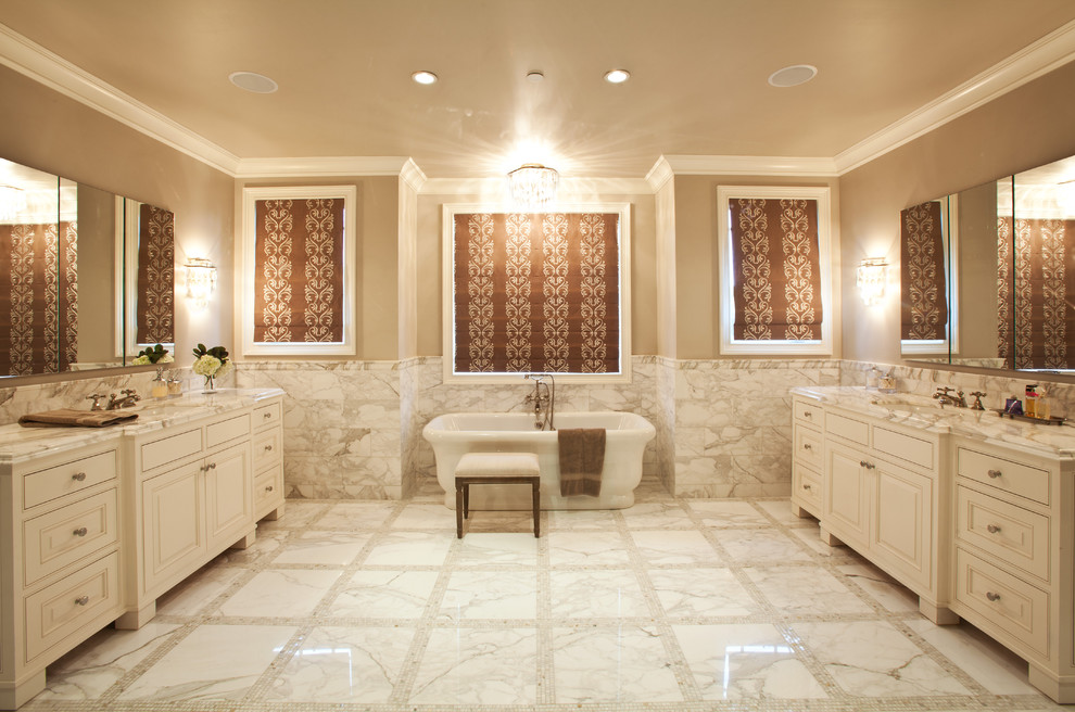 Design ideas for a traditional bathroom in Los Angeles with a freestanding tub, marble benchtops and marble.