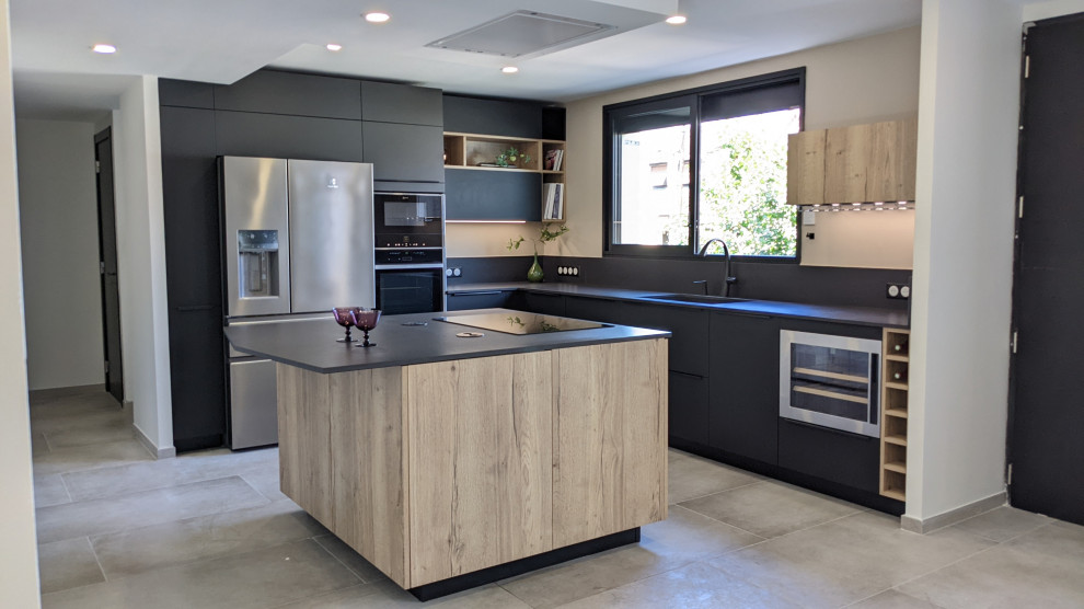 Inspiration for a large modern l-shaped eat-in kitchen in Other with an integrated sink, beaded inset cabinets, black cabinets, quartz benchtops, black splashback, engineered quartz splashback, stainless steel appliances, ceramic floors, with island, grey floor, black benchtop and recessed.