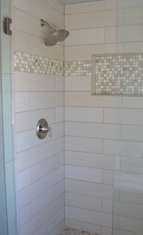 This is an example of a mid-sized transitional bathroom in Seattle with a double shower, beige tile and ceramic tile.